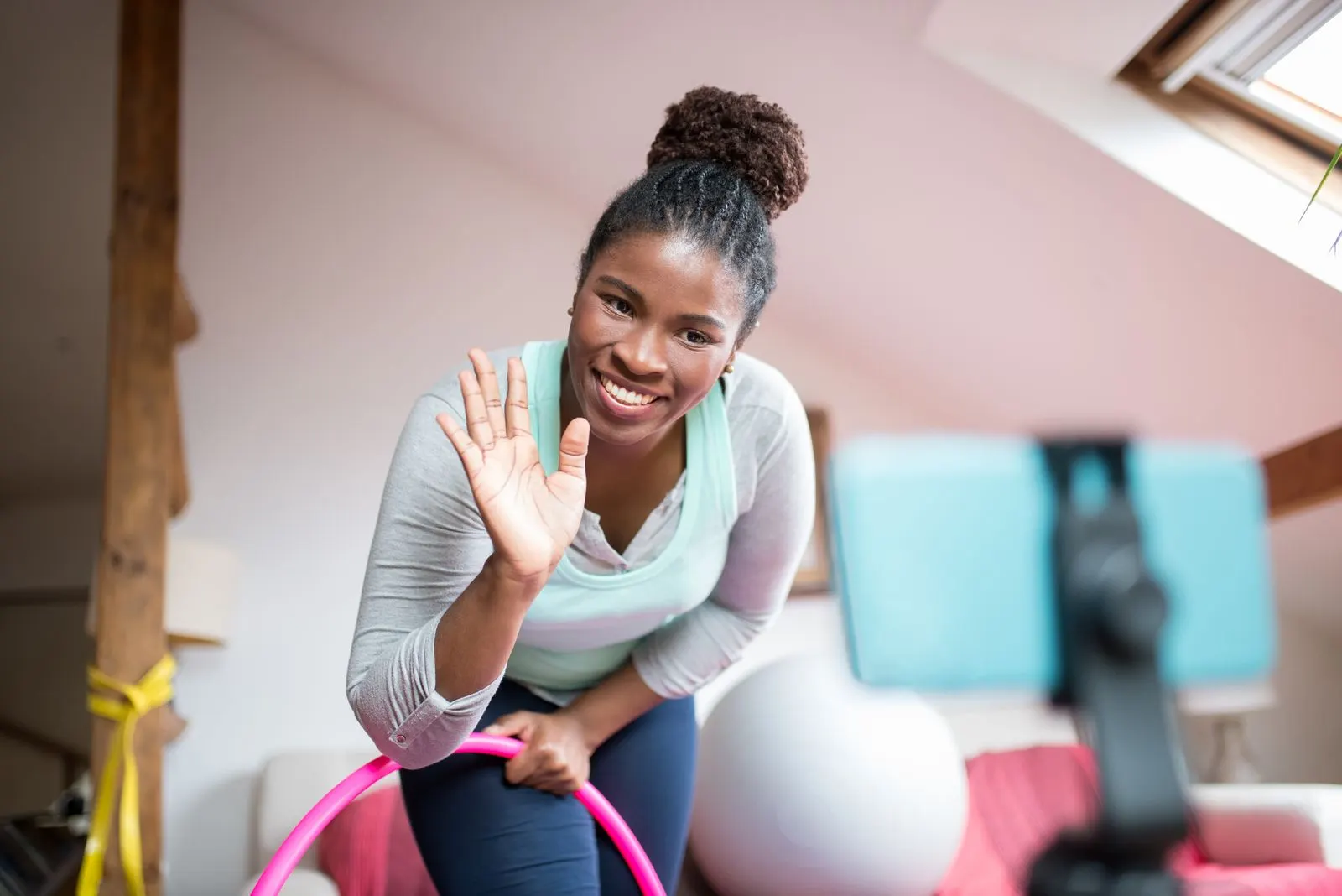 A trainer smiling while leading a session by video
